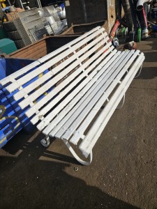 Large painted metal bench with wooden slats 
